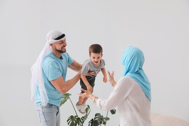 Photo of Happy Muslim family spending time together at home