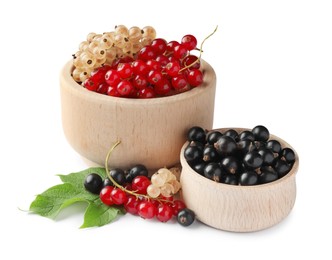 Photo of Fresh red, white and black currants in bowls with green leaf isolated on white