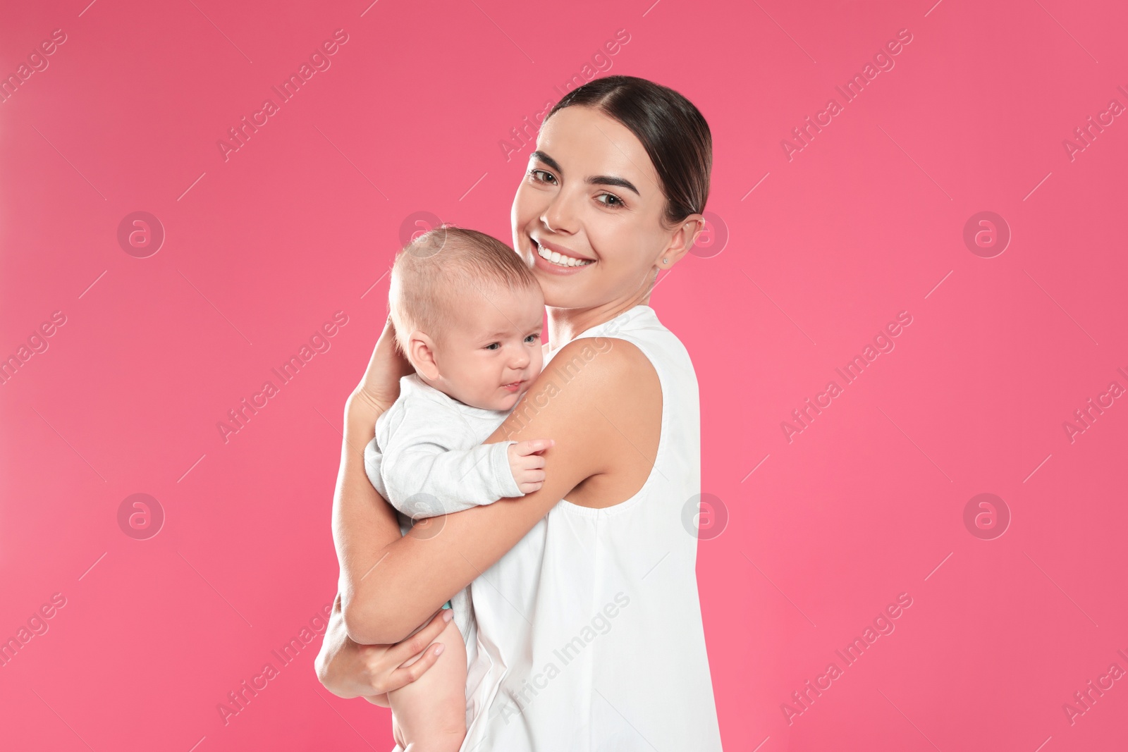 Photo of Portrait of happy mother with her baby on color background