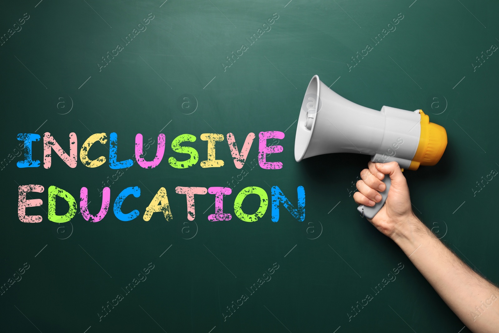 Image of Closeup view of man with megaphone and phrase INCLUSIVE EDUCATION on green chalkboard