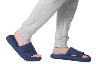 Man in blue slippers on white background, closeup