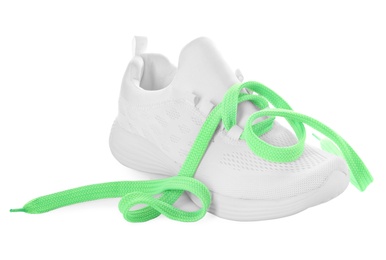 Photo of Stylish sneaker with light green shoelaces on white background