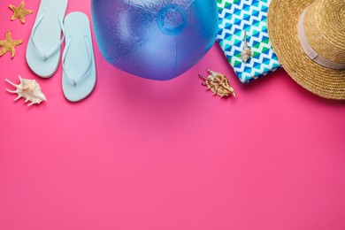 Photo of Flat lay composition with ball and beach objects on pink background, space for text