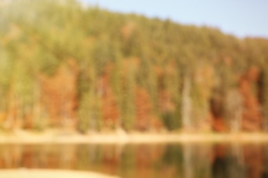 Beautiful mountain landscape with forest near water, blurred view