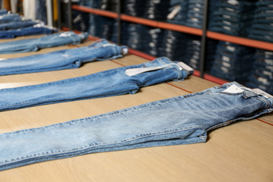 Photo of Stylish blue jeans on display in shop