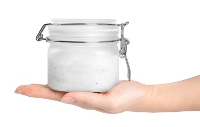 Woman holding jar of salt scrub on white background, closeup