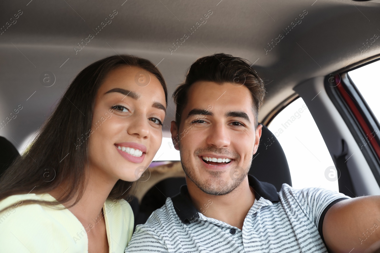 Photo of Happy young couple in car on road trip