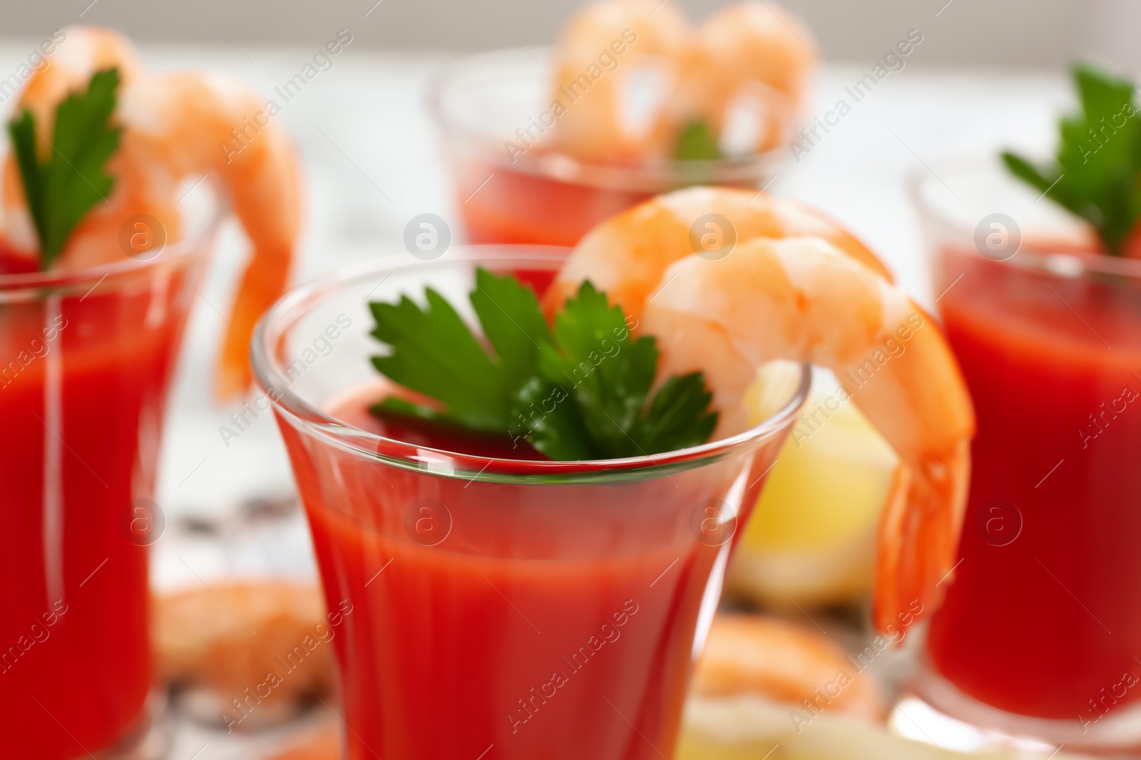 Photo of Delicious shrimp cocktail with tomato sauce, closeup