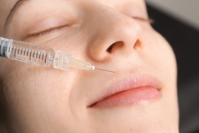 Photo of Client getting lips injection, closeup. Cosmetology procedure