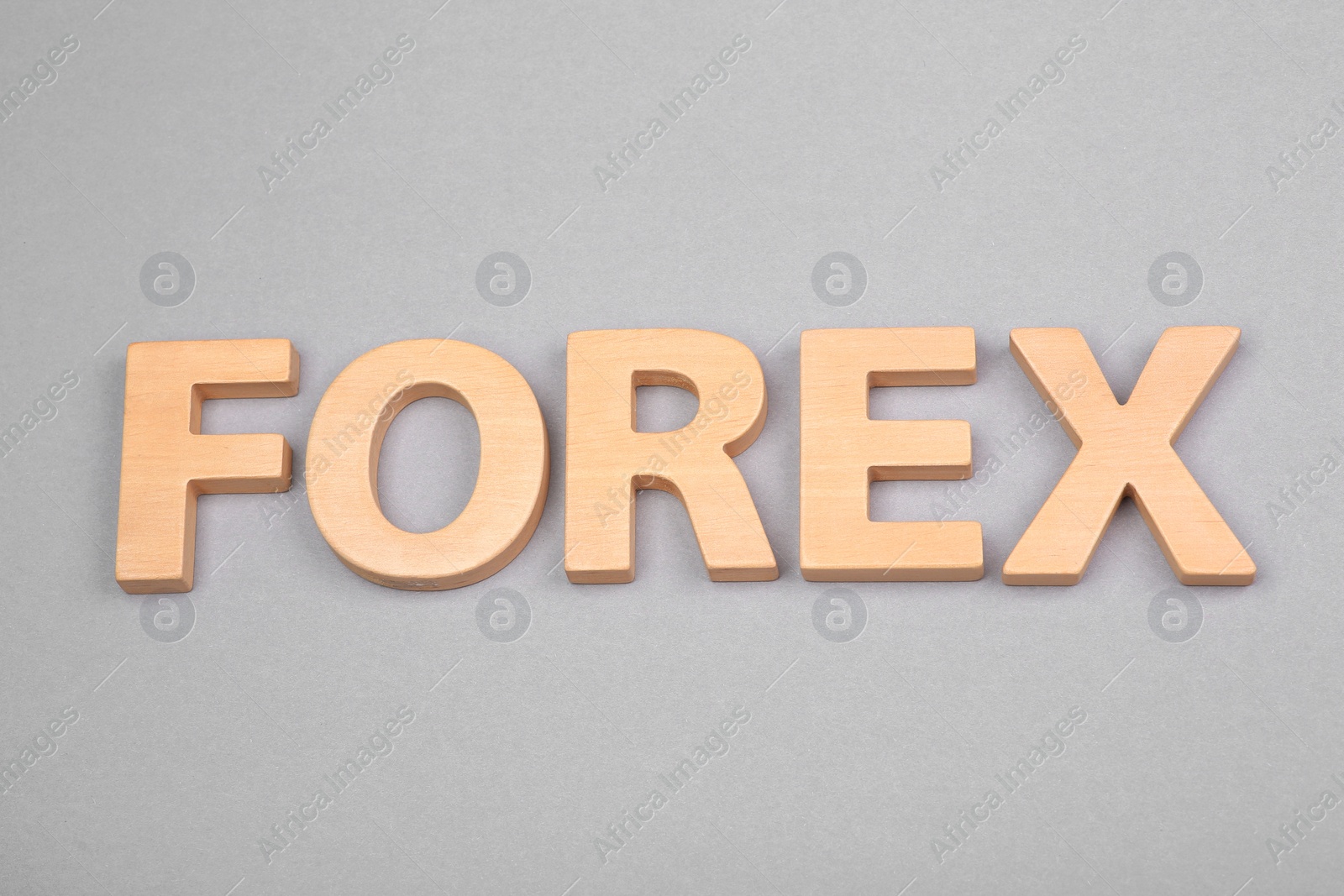 Photo of Word Forex with wooden letters on grey background, above view