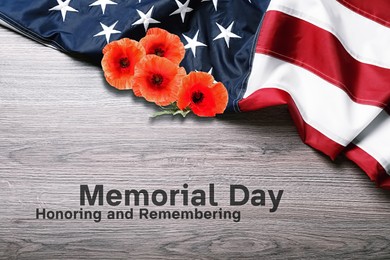 Image of Memorial Day, Honoring and Remembering. American flag and red poppy flowers on wooden background, top view