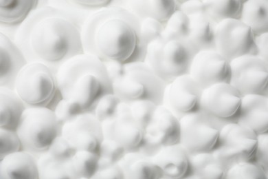 Photo of Texture of white shaving foam as background, top view