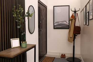 Photo of Modern hallway interior with stylish furniture and paintings