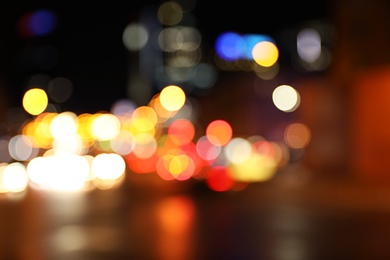 Photo of Blurred view of night city street with bokeh effect