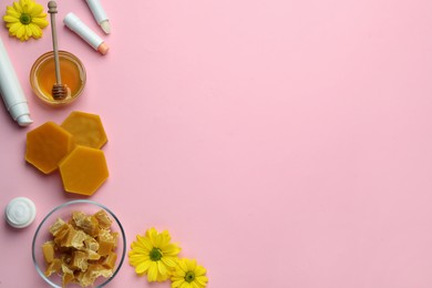 Flat lay composition with beeswax and cosmetic products on pink background. Space for text