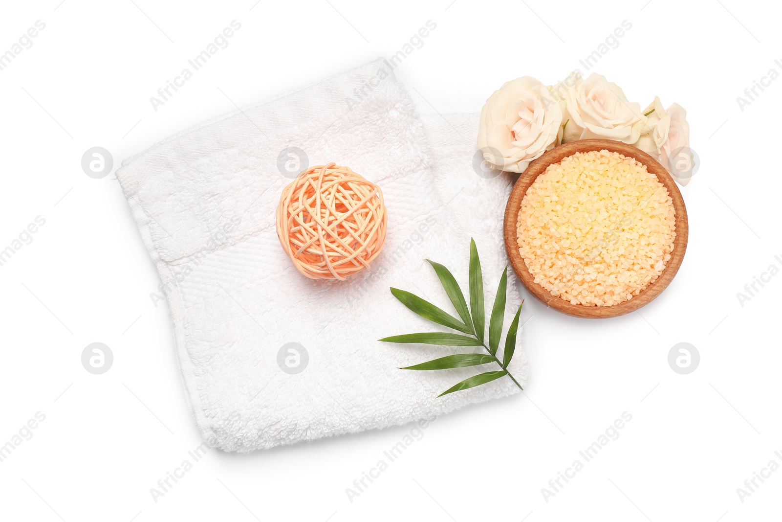 Photo of Orange sea salt in bowl, towel, rattan ball and floral decor isolated on white, top view
