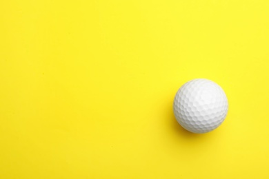 Photo of Golf ball on color background, top view. Space for text