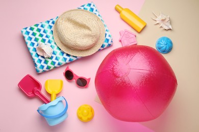 Photo of Flat lay composition with beach ball, sand toys and accessories on color background