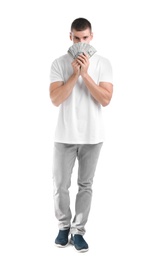 Handsome young man with dollars on white background