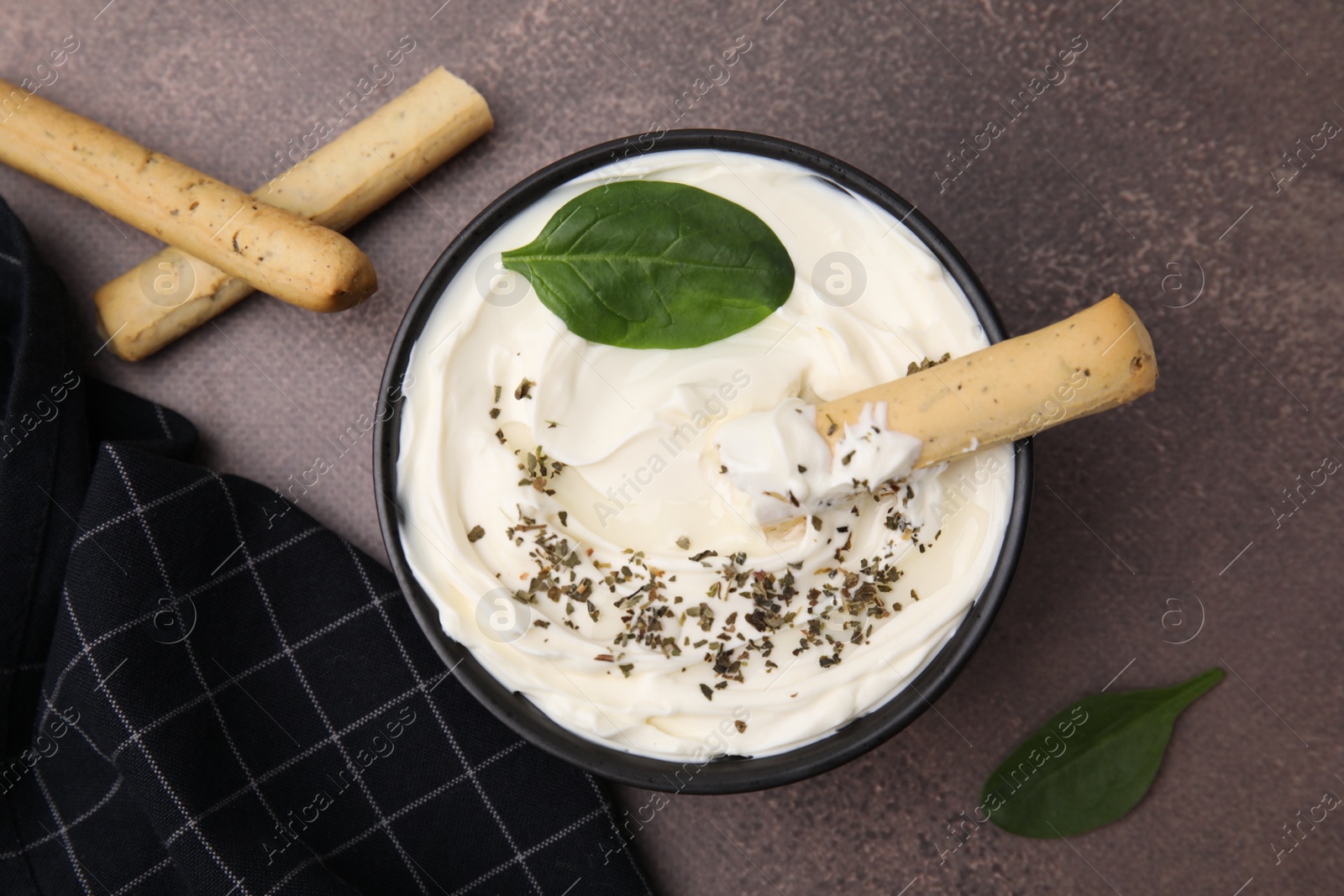 Photo of Delicious cream cheese with grissini stick and spices on grey table, flat lay