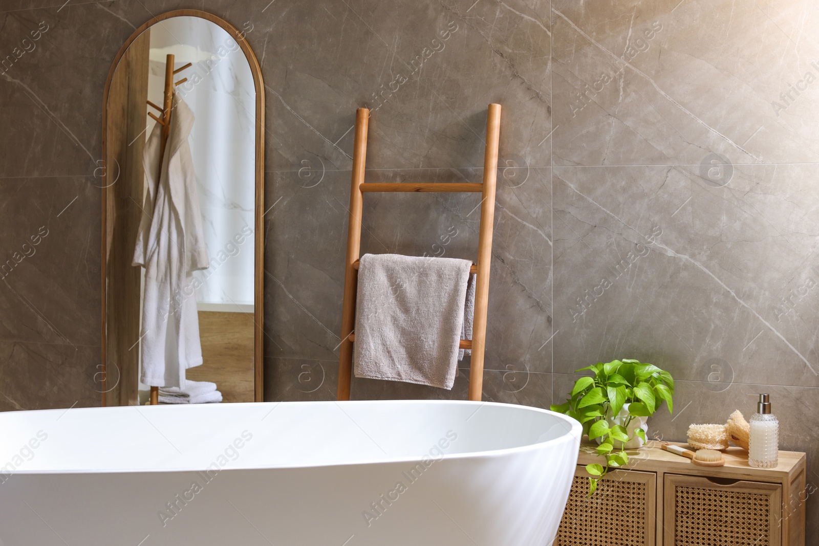 Photo of Stylish bathroom interior with white tub. Idea for design