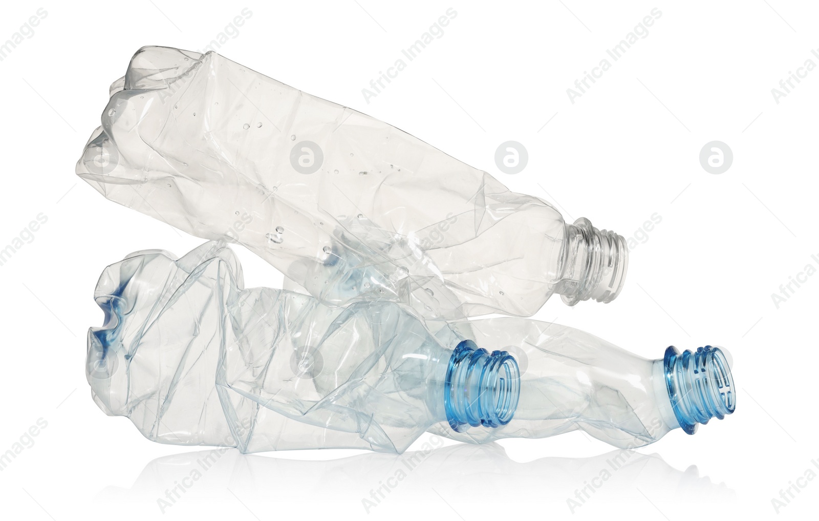 Photo of Crumpled disposable plastic bottles isolated on white