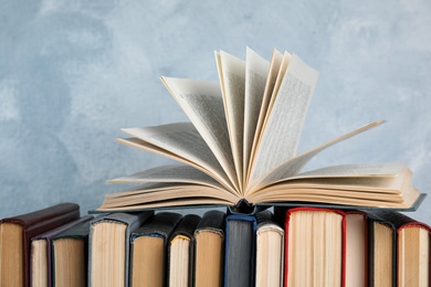 Photo of Stack of hardcover books on light blue background