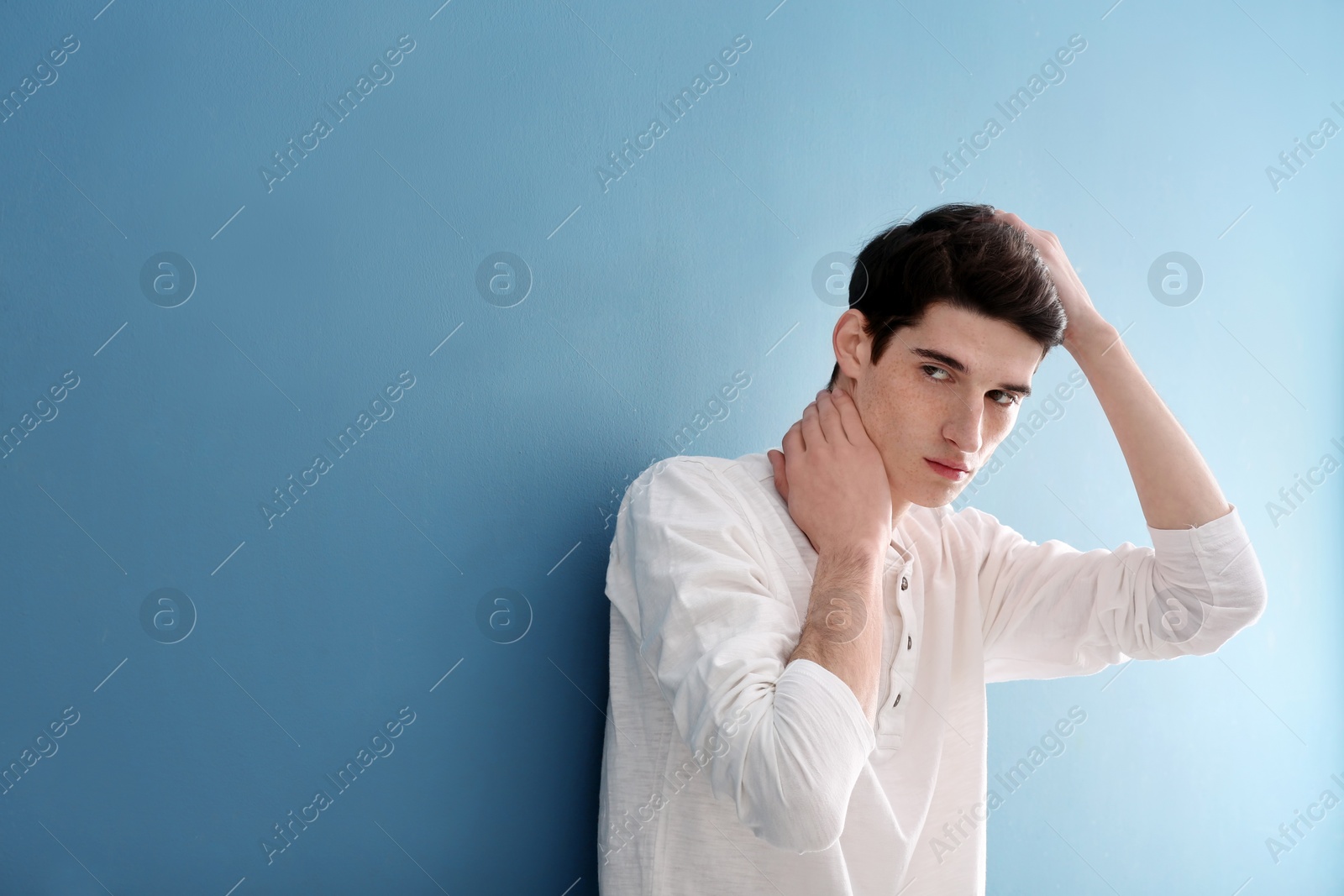 Photo of Portrait of young man with beautiful hair on color background