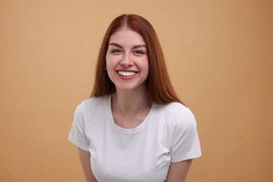 Portrait of smiling woman on beige background