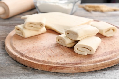 Wooden board with fresh dough on table. Puff pastry