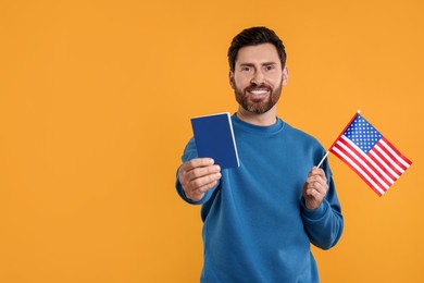 Photo of Immigration. Happy man with passport and American flag on orange background, space for text