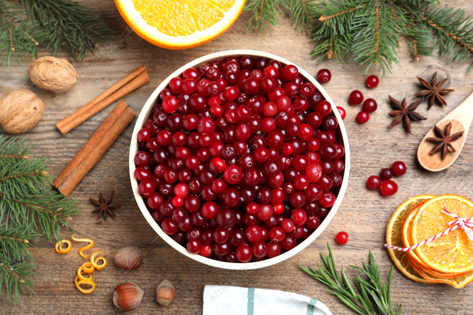 Photo of Flat lay composition with fresh ripe cranberries on wooden table