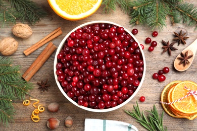 Flat lay composition with fresh ripe cranberries on wooden table