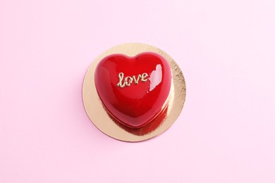 St. Valentine's Day. Delicious heart shaped cake on light pink background, top view