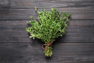 Bunch of aromatic thyme on wooden table, top view
