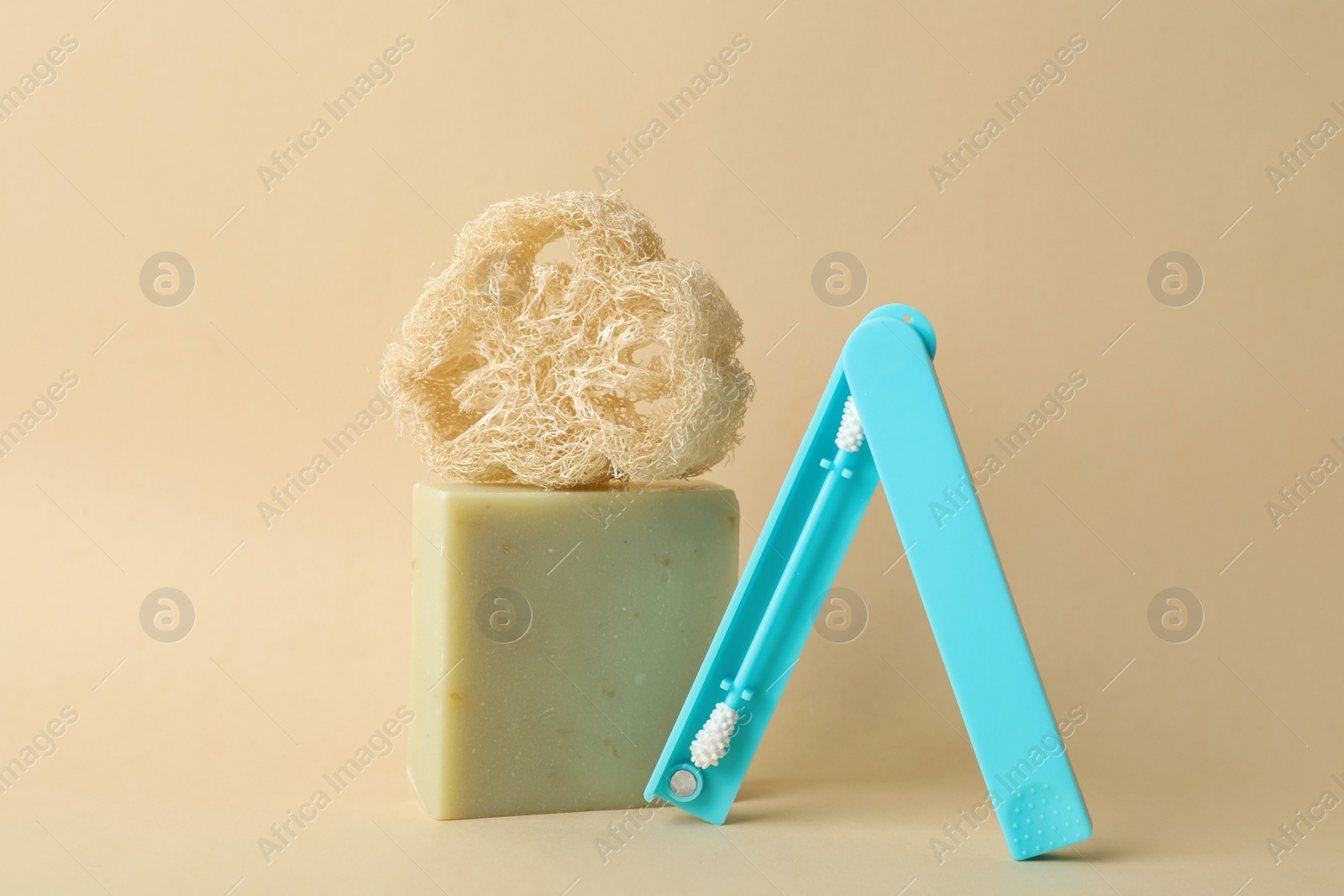 Photo of Natural loofah, reusable ear swab and soap bar on beige background. Conscious consumption