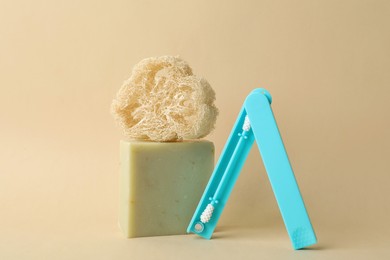 Natural loofah, reusable ear swab and soap bar on beige background. Conscious consumption