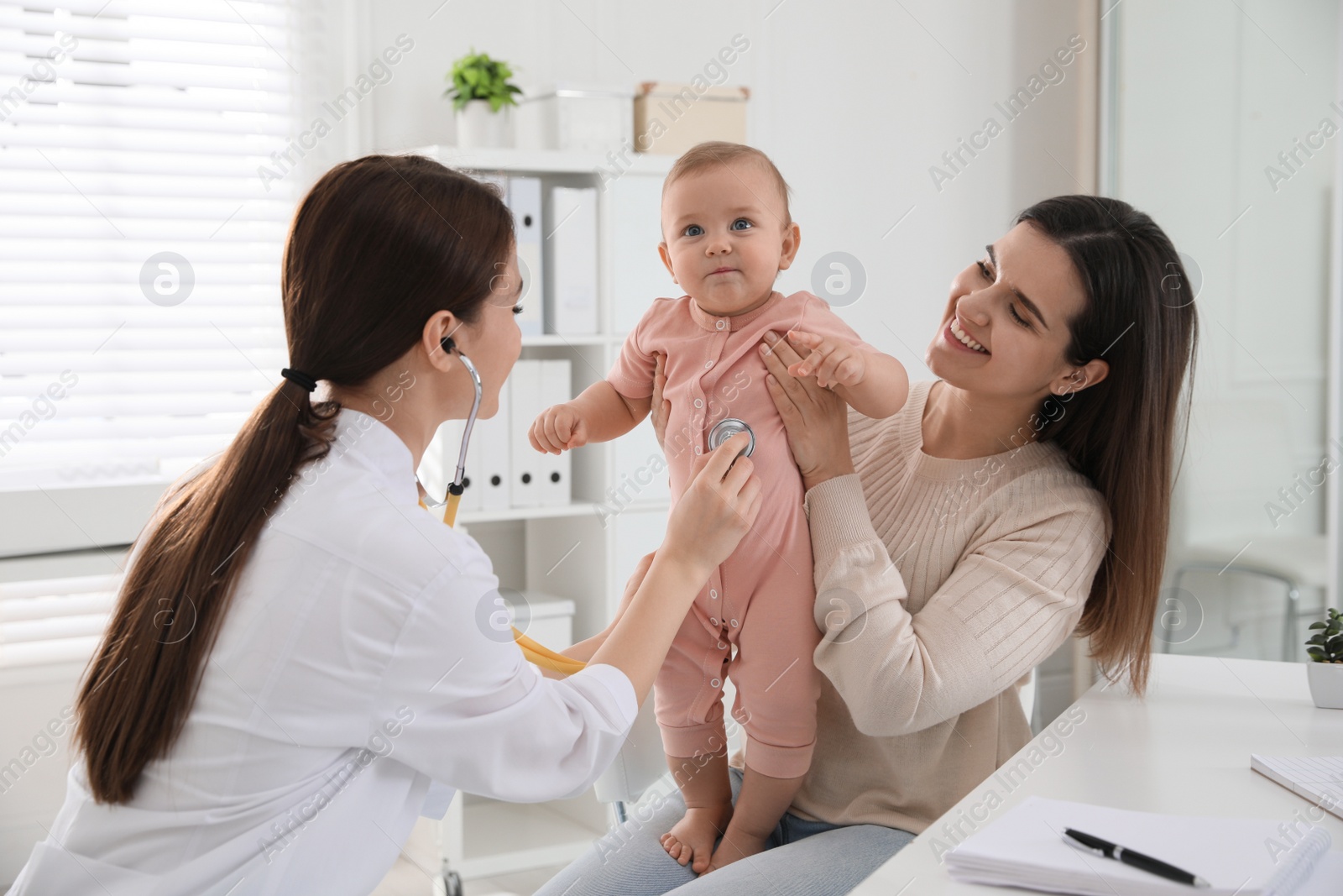 Photo of Mother with her cute baby visiting pediatrician in clinic