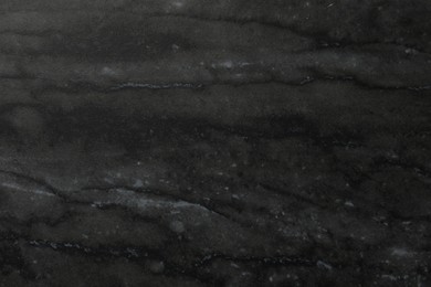 Black marble surface as background, closeup view