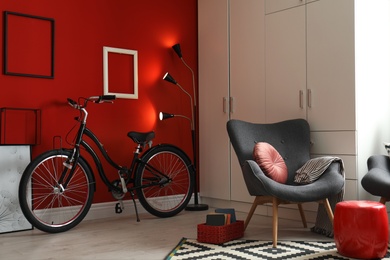 Modern living room interior with comfortable armchair and bicycle