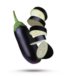 Image of Cut and whole eggplants in air against white background