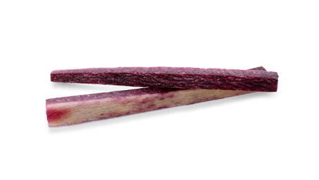 Raw purple carrot sticks isolated on white