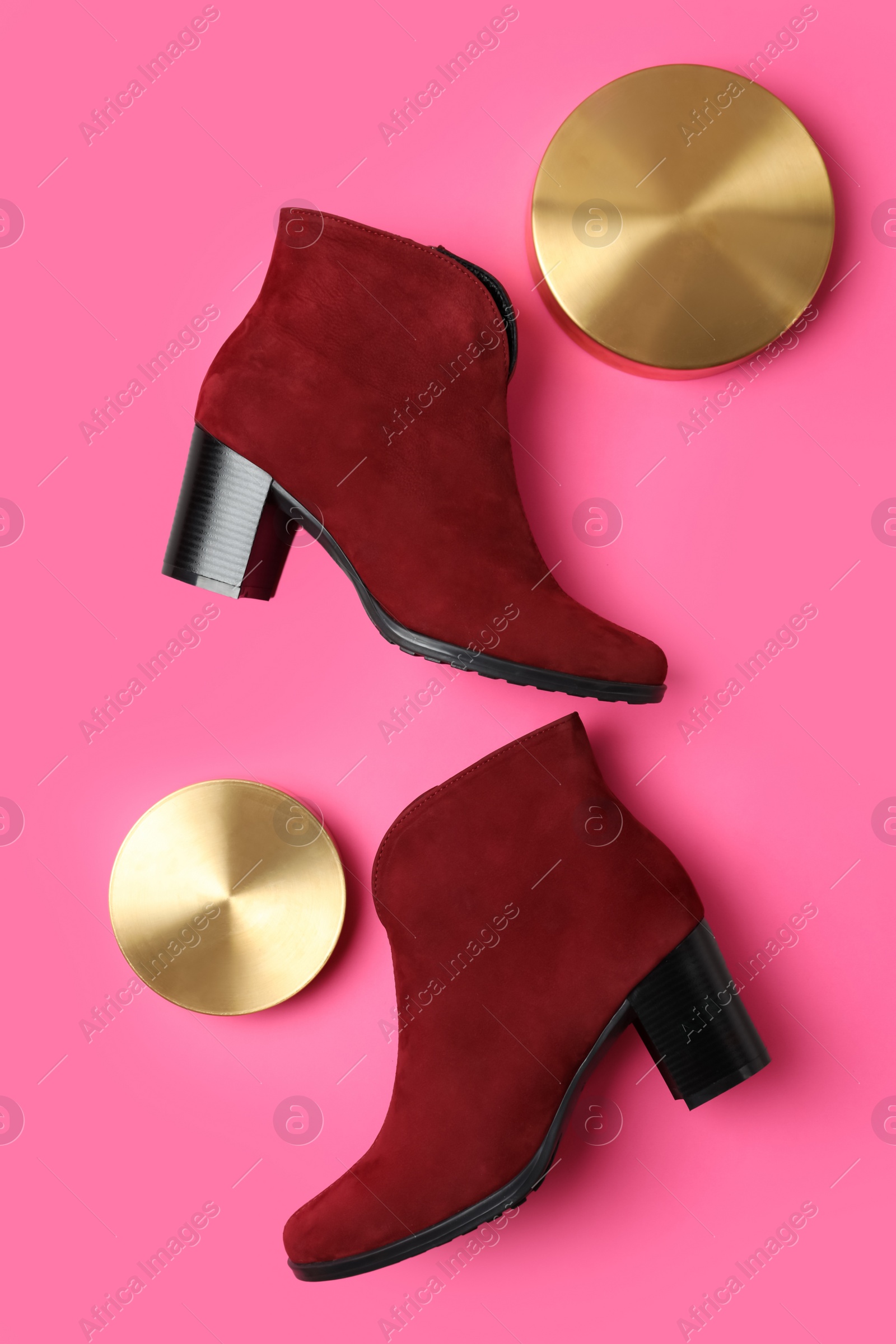 Photo of Stylish red female boots and decor on pink background, flat lay