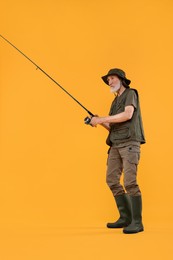 Photo of Fisherman with fishing rod on yellow background