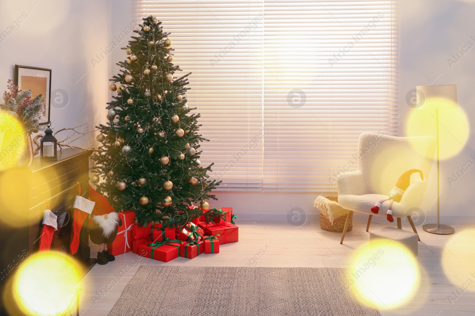 Photo of Beautifully wrapped gift boxes under Christmas tree in living room