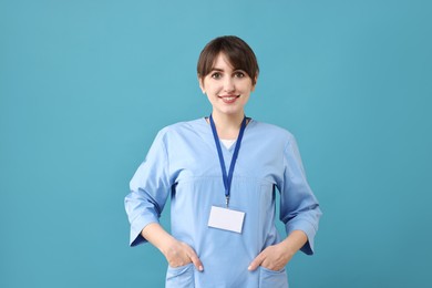 Photo of Portrait of smiling medical assistant on light blue background