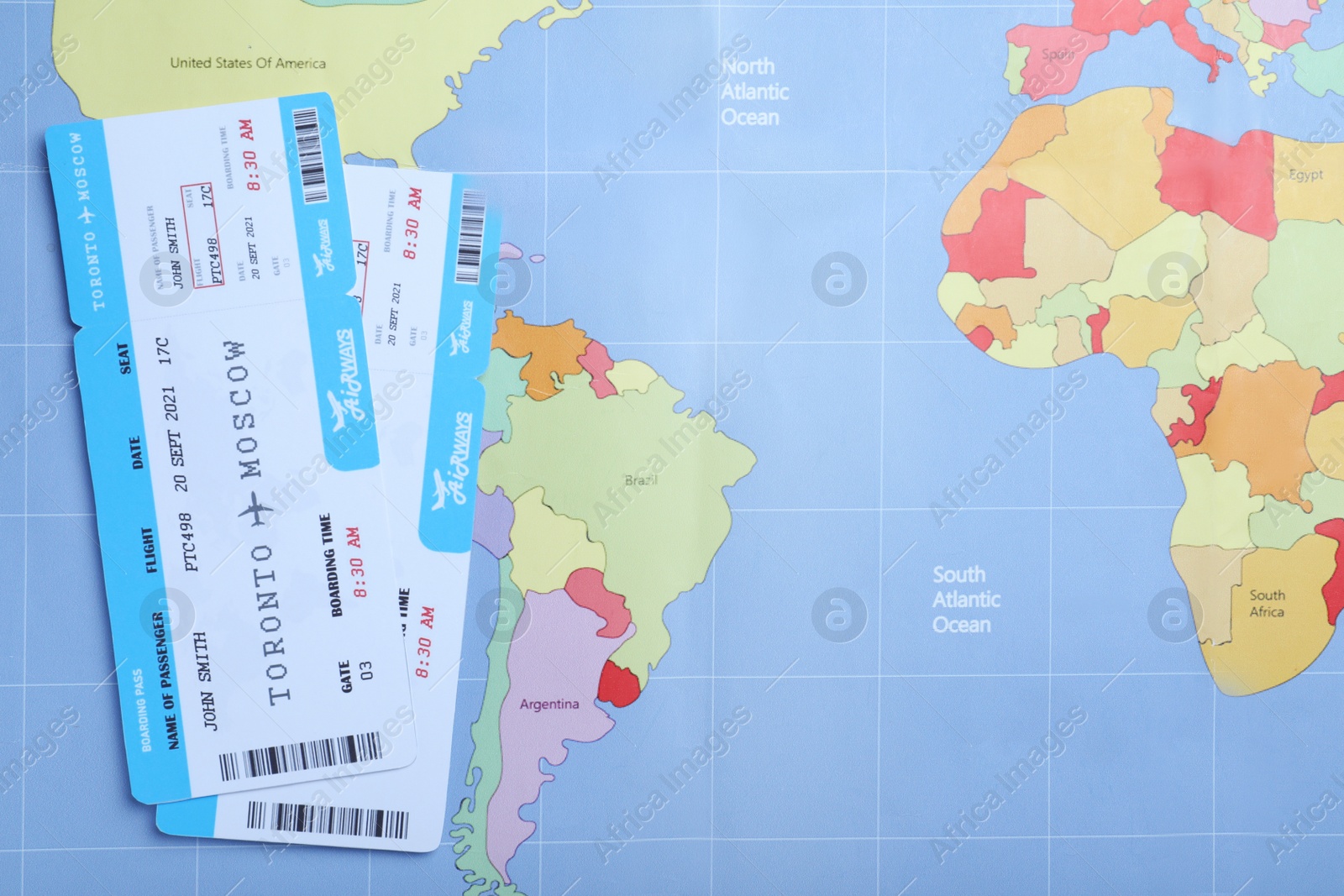 Photo of Tickets on world map, flat lay. Travel agency concept