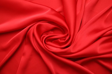 Photo of Texture of delicate red silk as background, top view