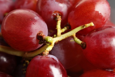 Photo of Bunch of red fresh ripe juicy grapes as background, closeup