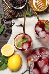 Photo of Flat lay composition with refreshing hibiscus tea on wooden table